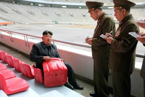 Kim jong un holding a chair